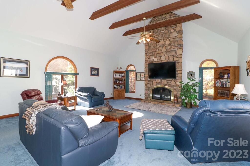 3449 Lee Moore Road Maiden, NC 28650 - Photo 24 of 48 a living room with furniture a fireplace and a flat screen tv