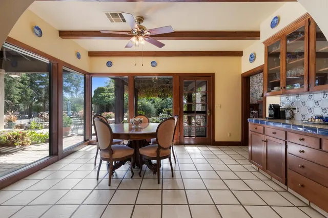 a living room with furniture a rug and a large window