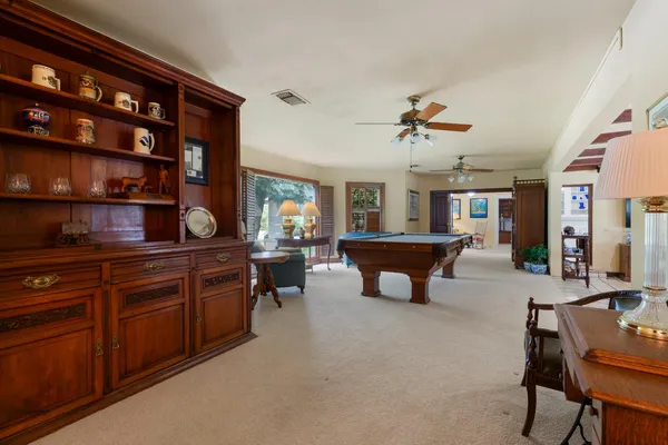 a living room with furniture a window and a flat screen tv