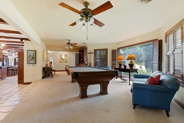 a bedroom with a bed and a dresser next to a window