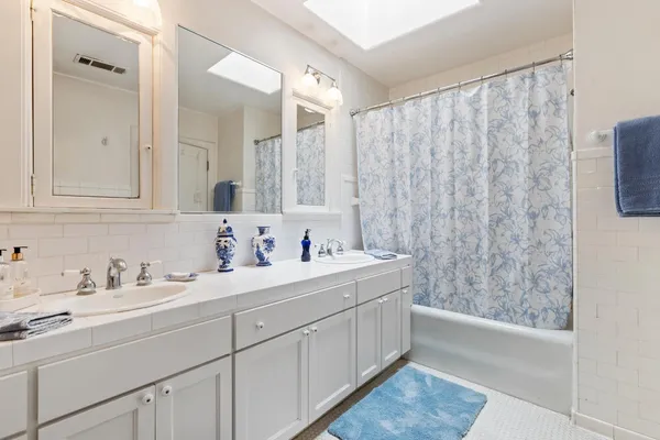 a large bedroom with a bed and large windows