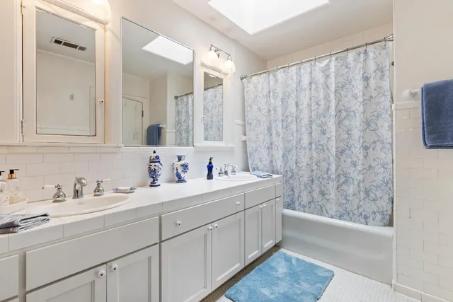 a large bedroom with a bed and large windows