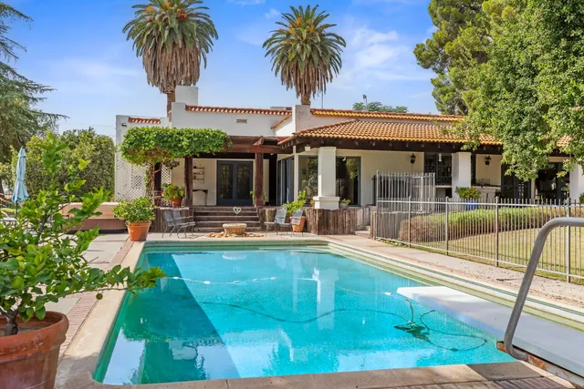 a view of house with a swimming pool