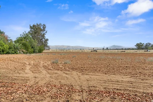 an aerial view of a residential houses with outdoor space and street view