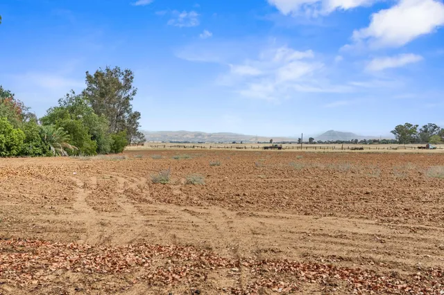 an aerial view of a residential houses with outdoor space and street view