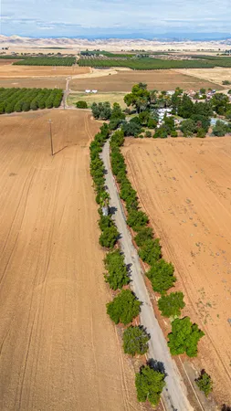 an aerial view of a house with a yard and lake view