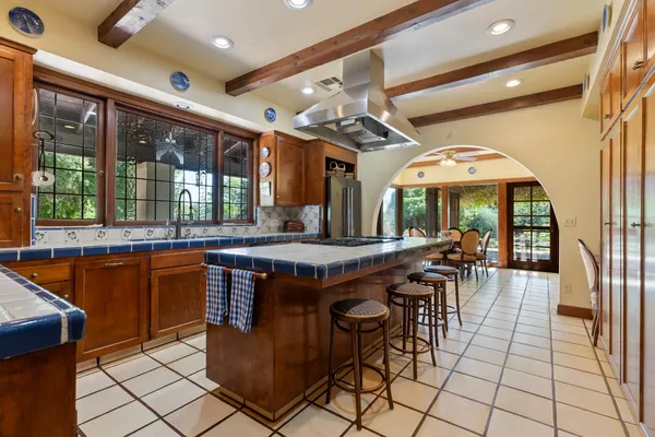 a dining room with furniture a chandelier and a large window
