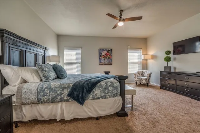 a spacious bedroom with a bed a window and a couch