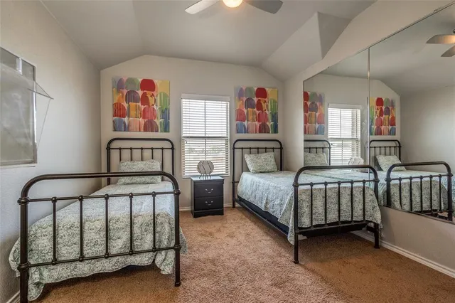 a bedroom with two beds and a baby crib