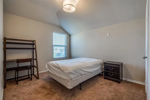 a bedroom with a bed and a chair