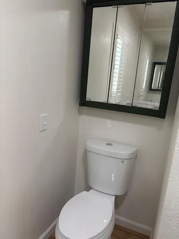 a white toilet sitting next to a bathroom sink