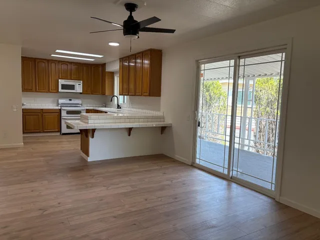 a view of kitchen with sink and wooden floor