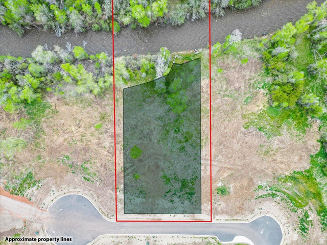 829 River Haven Road, Unit 111 Oakley, UT 84055 - Photo 6 of 12 Expansive undeveloped parcel featuring a river frontage, a wooded border, and direct road access
