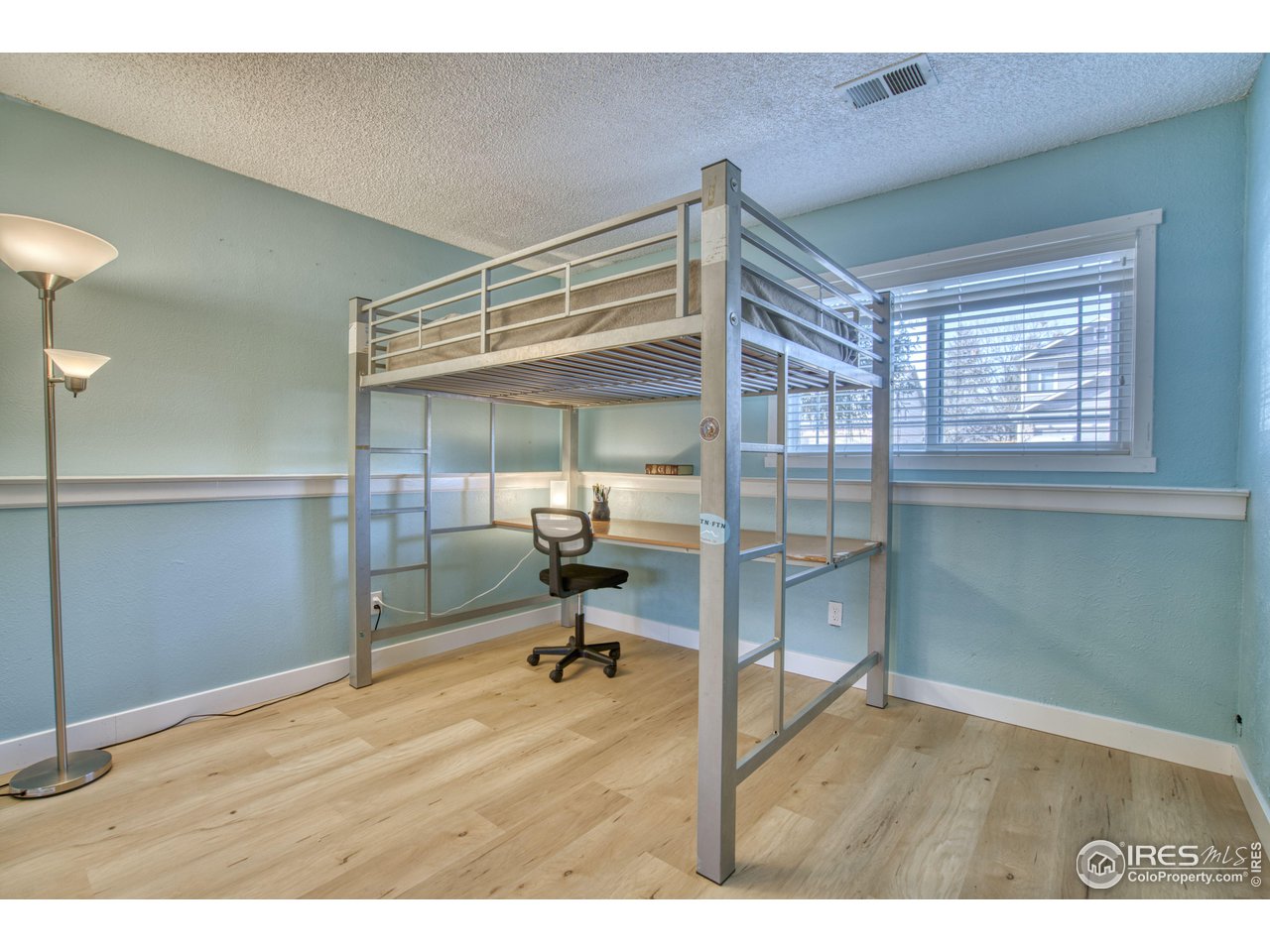 2154 Stuart Street Longmont, CO 80501 - Photo 13 of 27 a room that has a bed and a chair in it