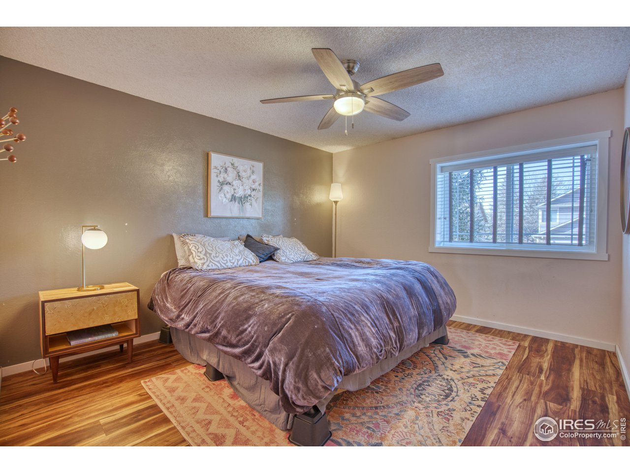2154 Stuart Street Longmont, CO 80501 - Photo 14 of 27 a bedroom with a bed and a ceiling fan