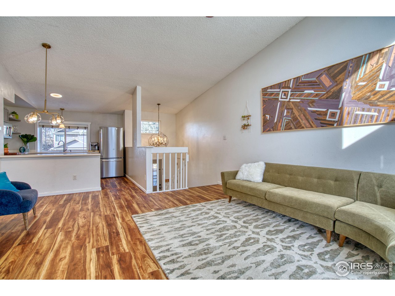 2154 Stuart Street Longmont, CO 80501 - Photo 22 of 27 a living room with furniture and kitchen view