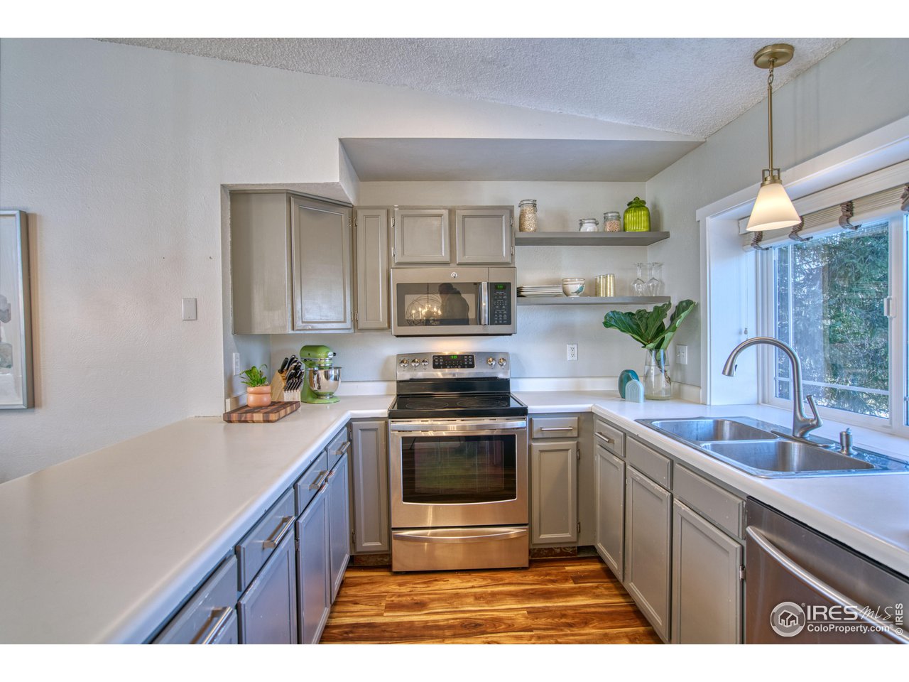 2154 Stuart Street Longmont, CO 80501 - Photo 4 of 27 a kitchen with a sink stove and cabinets