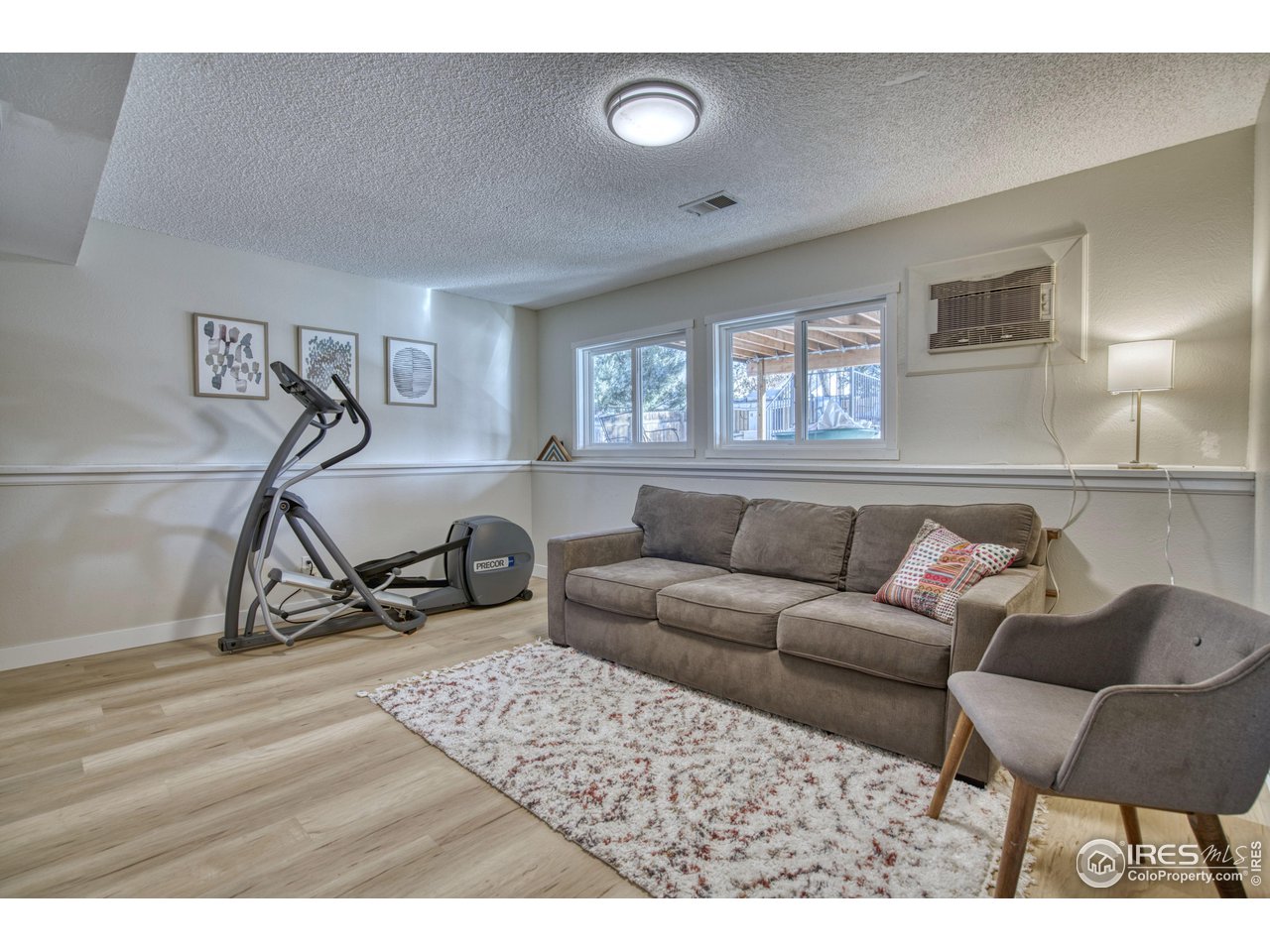 2154 Stuart Street Longmont, CO 80501 - Photo 7 of 27 a living room with furniture a air conditioner and a window