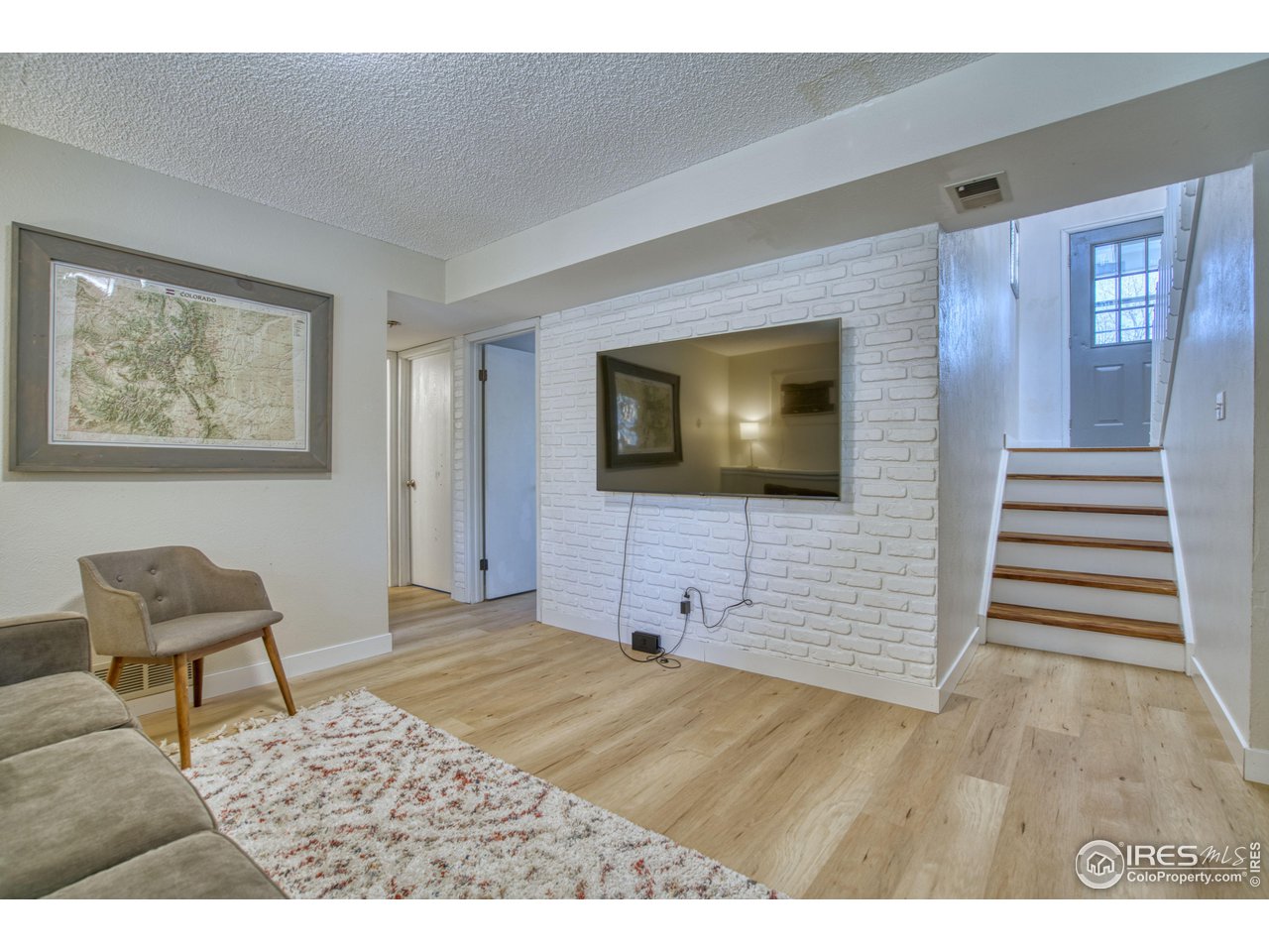 2154 Stuart Street Longmont, CO 80501 - Photo 8 of 27 a view of a livingroom with wooden floor and furniture