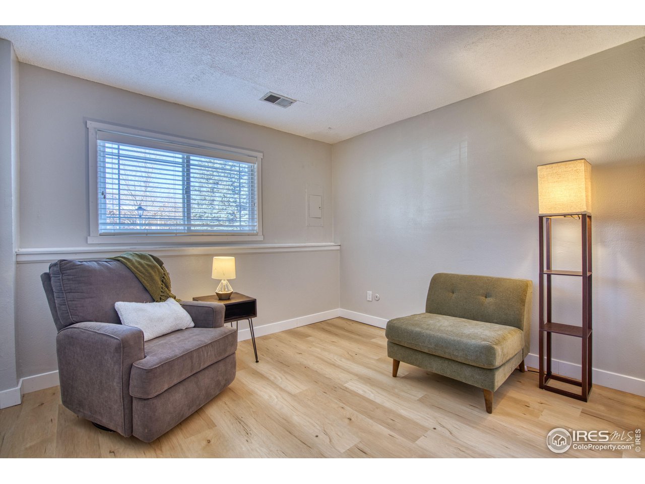 2154 Stuart Street Longmont, CO 80501 - Photo 10 of 27 a living room with furniture and a window