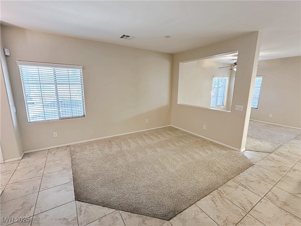 9620 Sharp Horn Court Las Vegas, NV 89149 - Photo 18 of 40 Unfurnished room with light colored carpet, ceiling fan, and light tile patterned floors