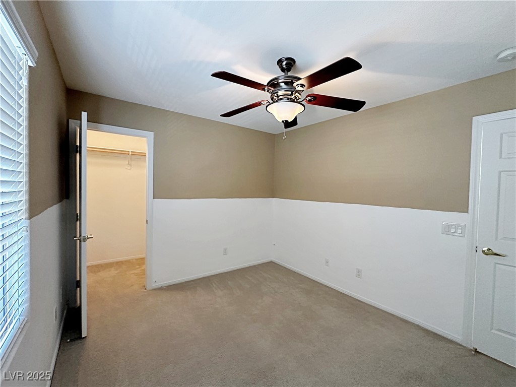 9620 Sharp Horn Court Las Vegas, NV 89149 - Photo 24 of 40 Unfurnished bedroom with a spacious closet, carpet, and a ceiling fan