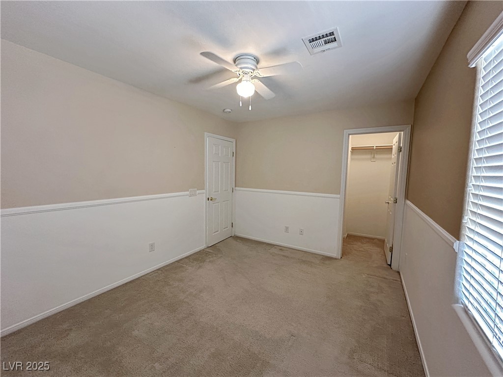 9620 Sharp Horn Court Las Vegas, NV 89149 - Photo 26 of 40 Unfurnished bedroom featuring a spacious closet, light colored carpet, and ceiling fan