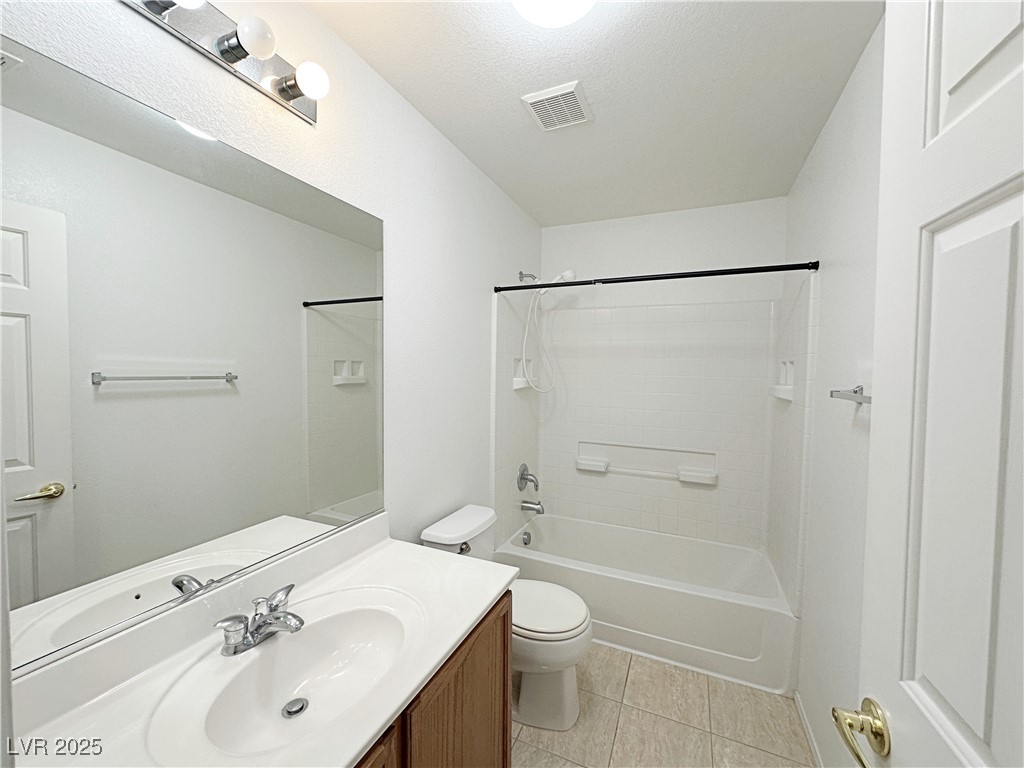 9620 Sharp Horn Court Las Vegas, NV 89149 - Photo 27 of 40 Full bathroom with vanity, shower / washtub combination, light tile patterned flooring, and a textured ceiling
