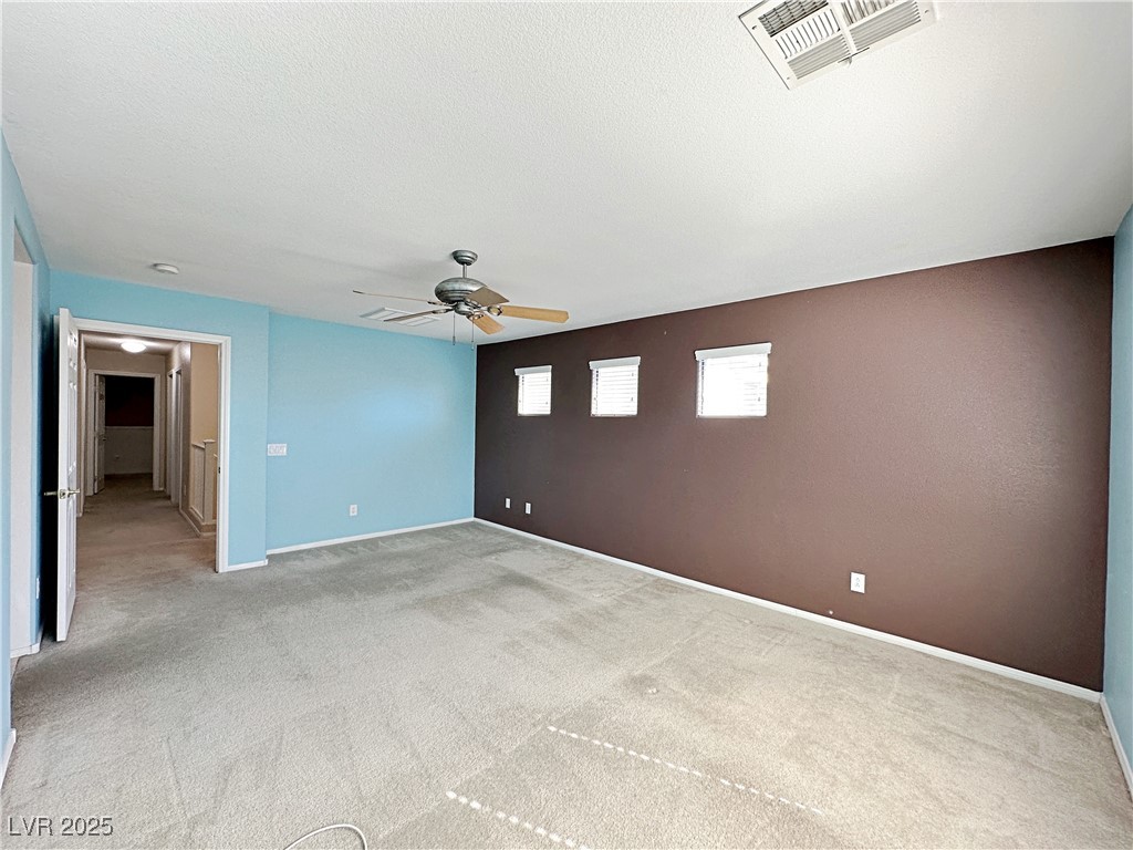 9620 Sharp Horn Court Las Vegas, NV 89149 - Photo 31 of 40 Carpeted spare room featuring a ceiling fan and a textured ceiling
