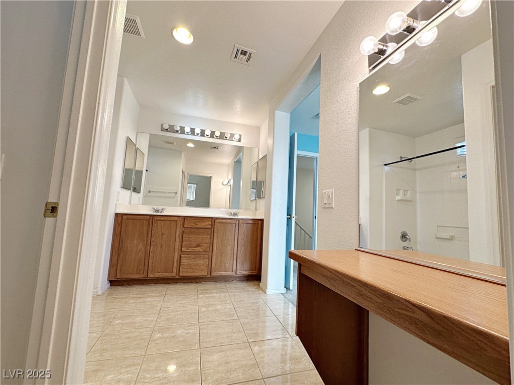9620 Sharp Horn Court Las Vegas, NV 89149 - Photo 33 of 40 Full bath featuring double vanity, light tile patterned flooring, recessed lighting, and a shower