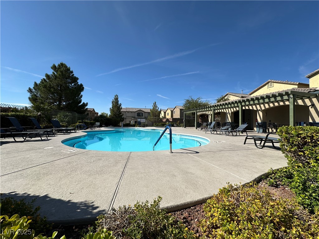 9620 Sharp Horn Court Las Vegas, NV 89149 - Photo 39 of 40 Community pool featuring a patio and a pergola