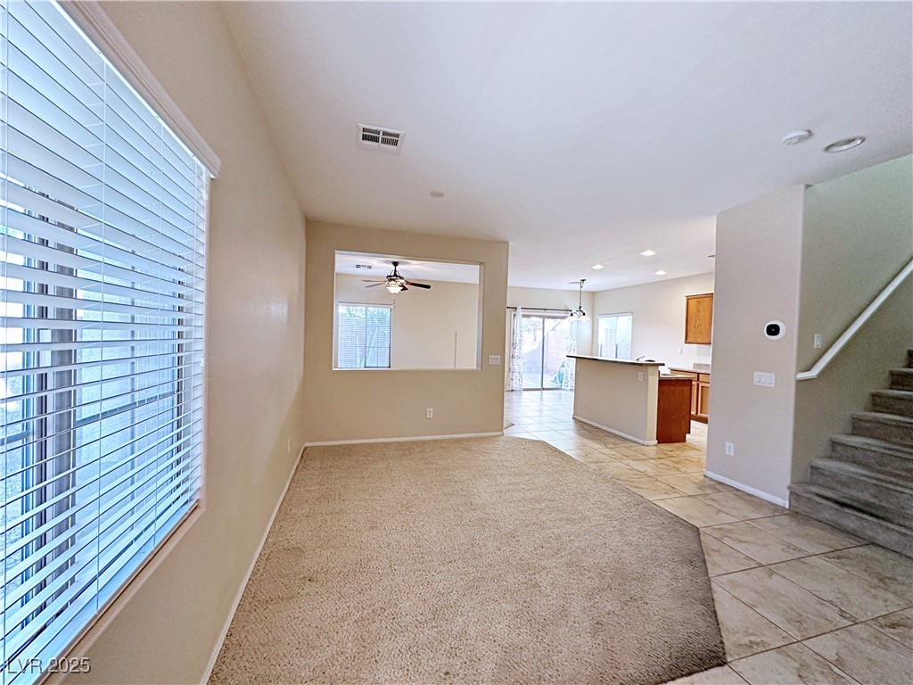 9620 Sharp Horn Court Las Vegas, NV 89149 - Photo 5 of 40 Unfurnished living room featuring light tile patterned floors, stairs, ceiling fan, and recessed lighting