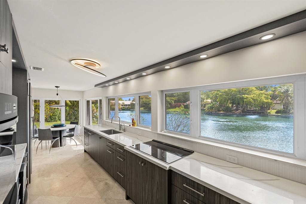 3150 North 35th Street Hollywood, FL 33021 - Photo 17 of 48 a large kitchen with kitchen island a large window in it