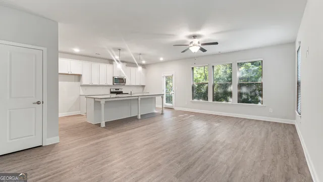 a view of kitchen with sink and refrigerator