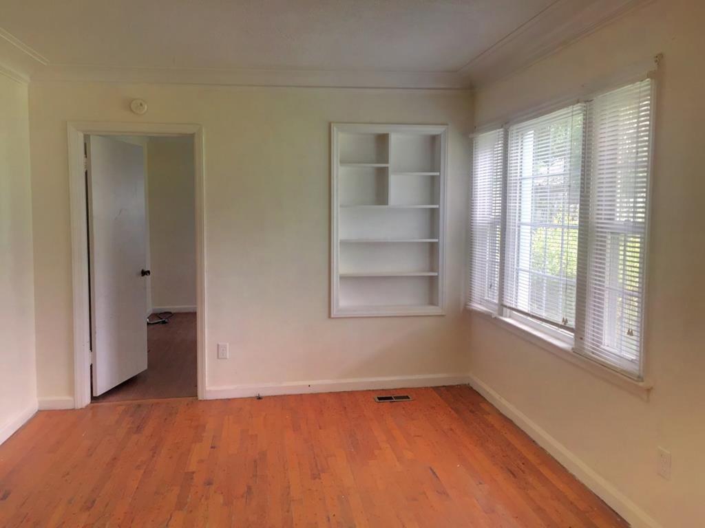 2651 Reese Road Columbus, GA 31907 - Photo 7 of 21 a view of an empty room with a window and wooden floor