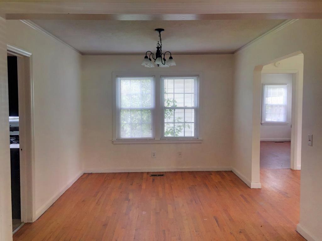 2651 Reese Road Columbus, GA 31907 - Photo 8 of 21 an empty room with wooden floor chandelier and windows