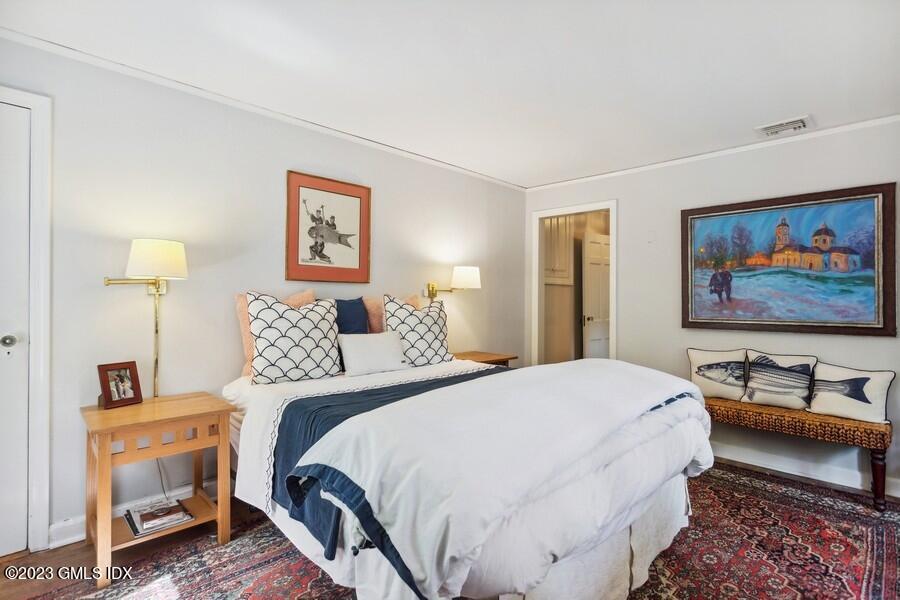 21 Stanwich Lane Greenwich, CT 06830 - Photo 20 of 45 a bedroom with a bed and a lamp on table