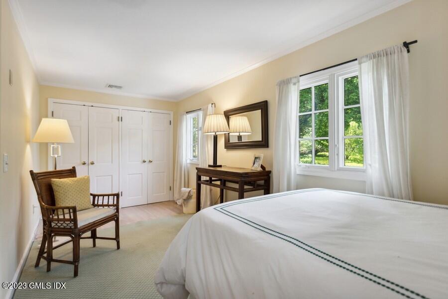21 Stanwich Lane Greenwich, CT 06830 - Photo 25 of 45 a bedroom with a bed a table and a window
