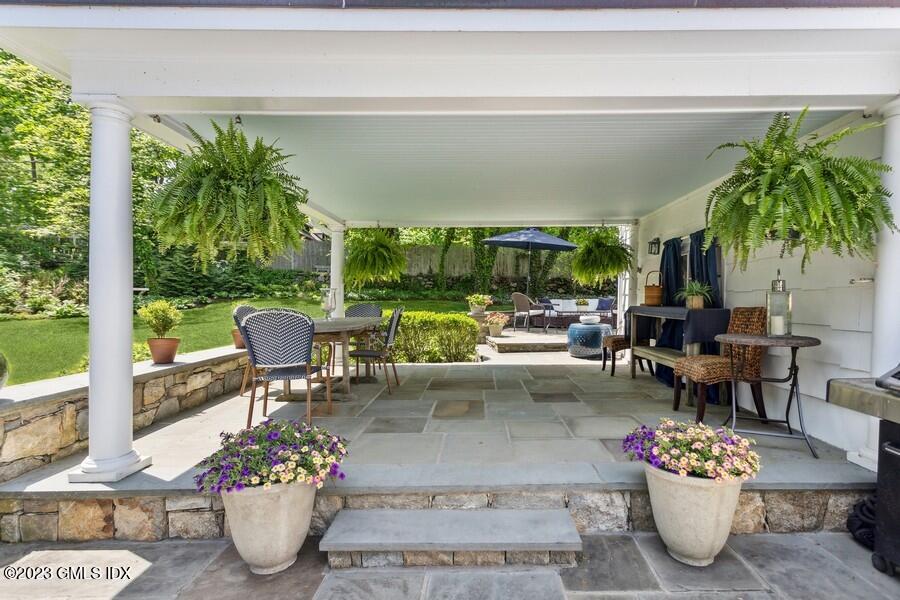 21 Stanwich Lane Greenwich, CT 06830 - Photo 30 of 45 a living room with furniture potted plant and a large window