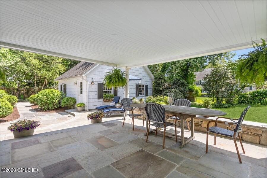 21 Stanwich Lane Greenwich, CT 06830 - Photo 32 of 45 a view of a patio with table and chairs potted plants with floor to ceiling window