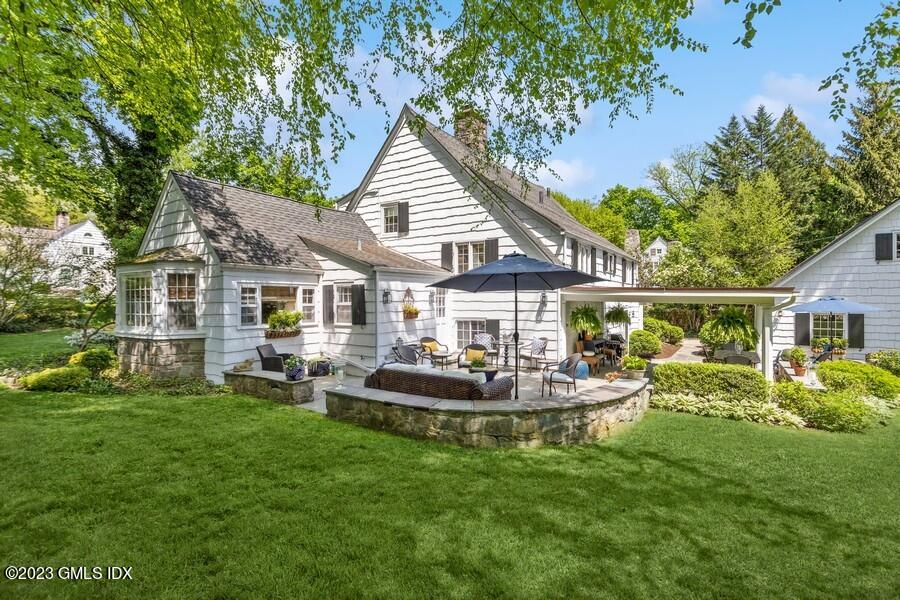 21 Stanwich Lane Greenwich, CT 06830 - Photo 35 of 45 a front view of house with a garden and patio