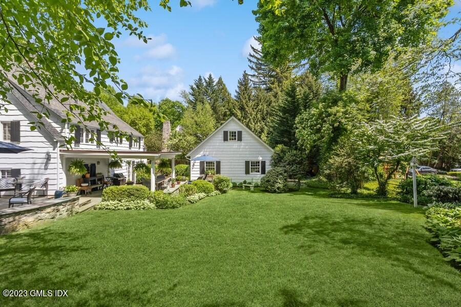 21 Stanwich Lane Greenwich, CT 06830 - Photo 38 of 45 a front view of a house with a garden