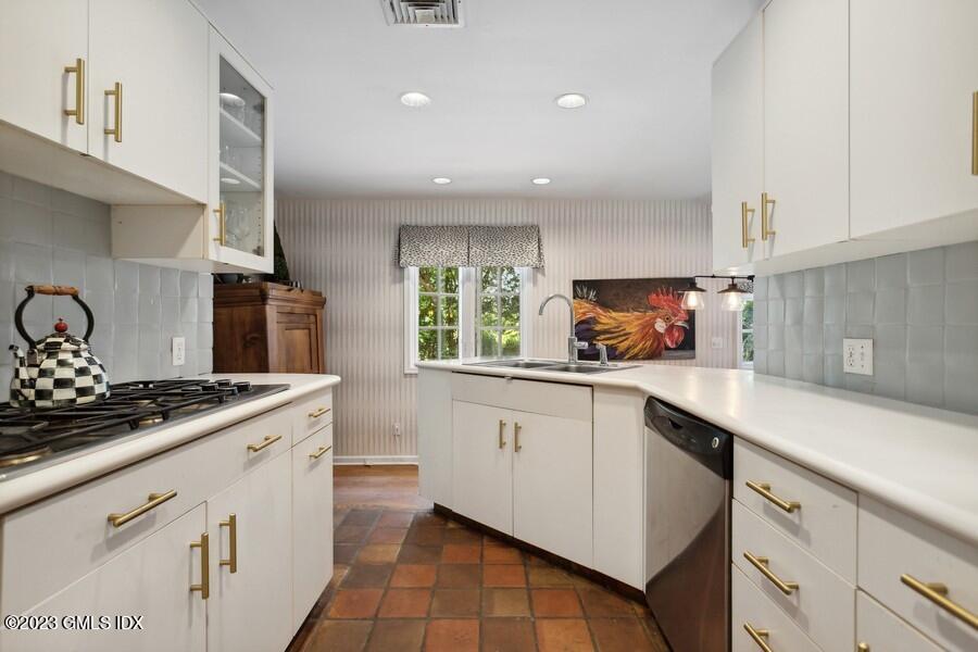 21 Stanwich Lane Greenwich, CT 06830 - Photo 9 of 45 a kitchen with a sink stove and cabinets