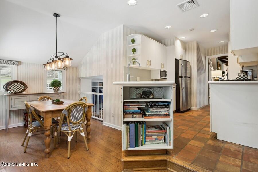 21 Stanwich Lane Greenwich, CT 06830 - Photo 10 of 45 a dining room filled chandelier and kitchen view