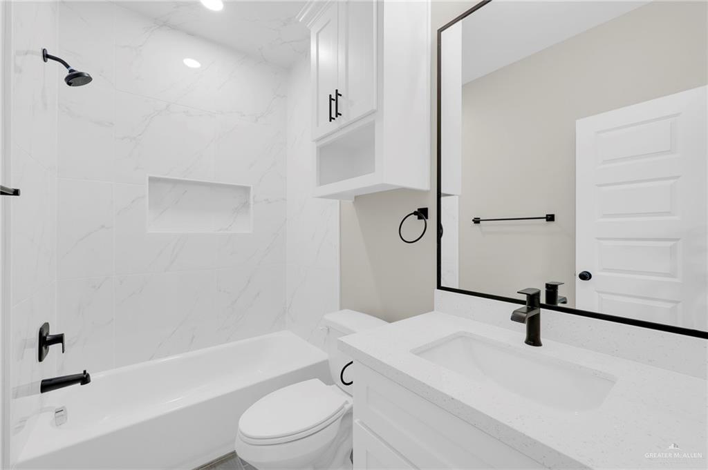 905 Crestview Street, Unit 2 Weslaco, TX 78596 - Photo 12 of 12 a bathroom with a sink a toilet and a bathtub
