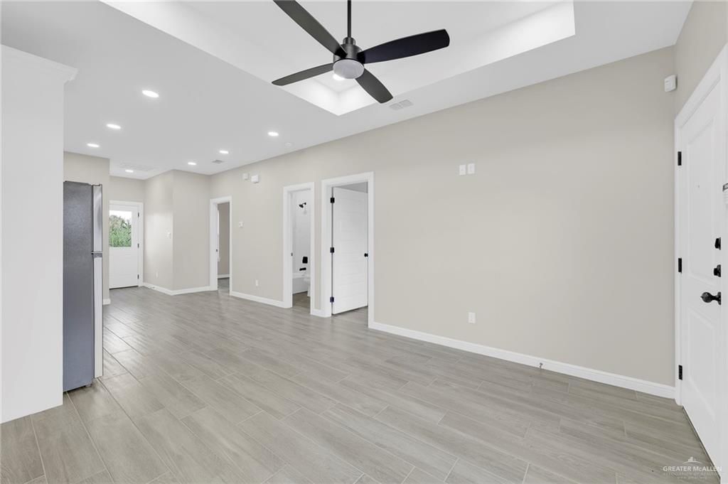 905 Crestview Street, Unit 2 Weslaco, TX 78596 - Photo 4 of 12 a view of an empty room with wooden floor