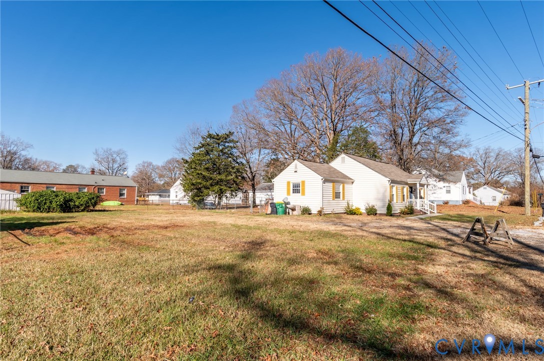 3203 Courthouse Road Hopewell, VA 23860 - Photo 19 of 23 a yellow house with trees in front of it