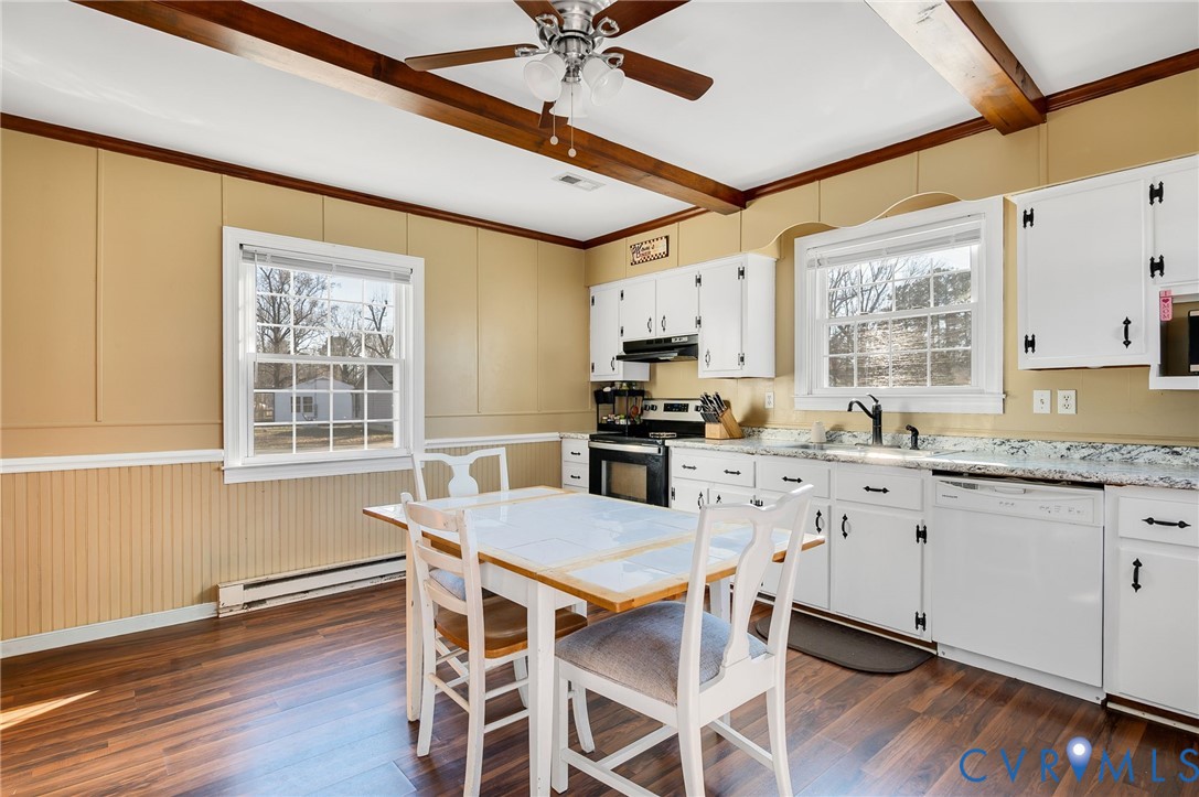 3203 Courthouse Road Hopewell, VA 23860 - Photo 8 of 23 a kitchen with granite countertop a table chairs stove and cabinets