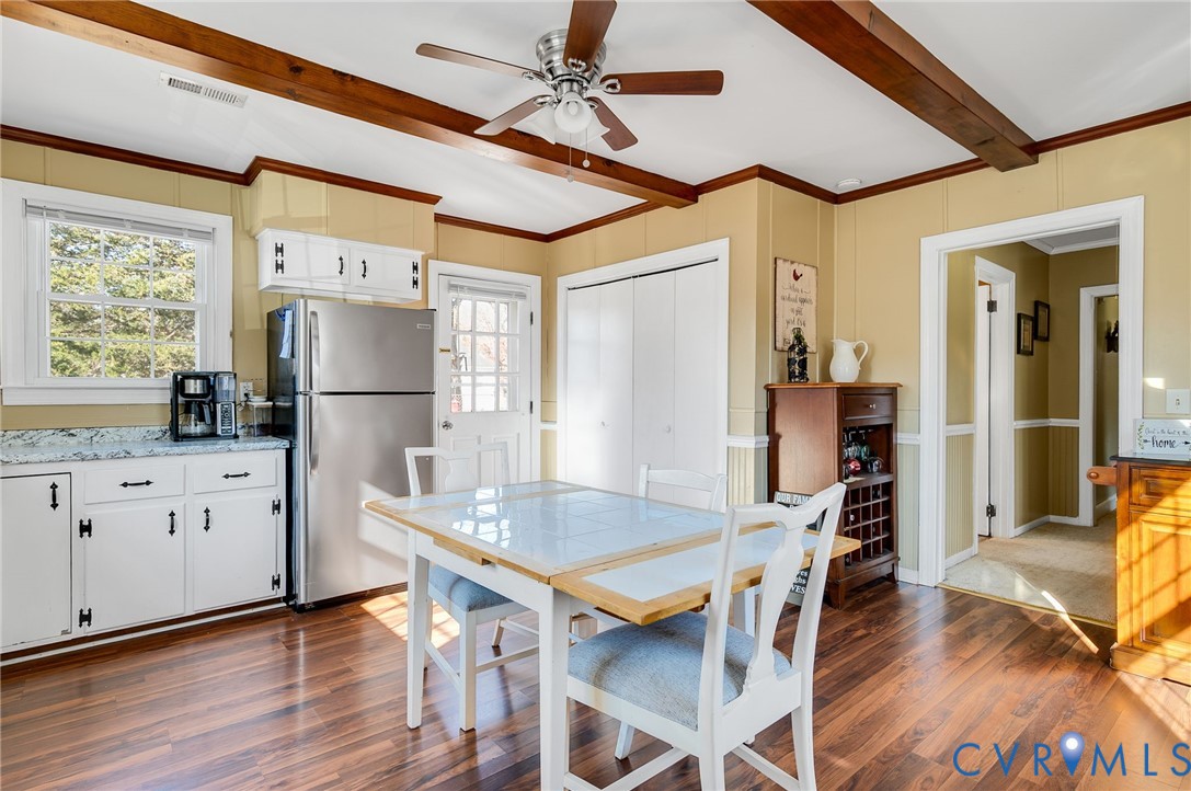 3203 Courthouse Road Hopewell, VA 23860 - Photo 9 of 23 a kitchen with refrigerator cabinets dining table and wooden floor