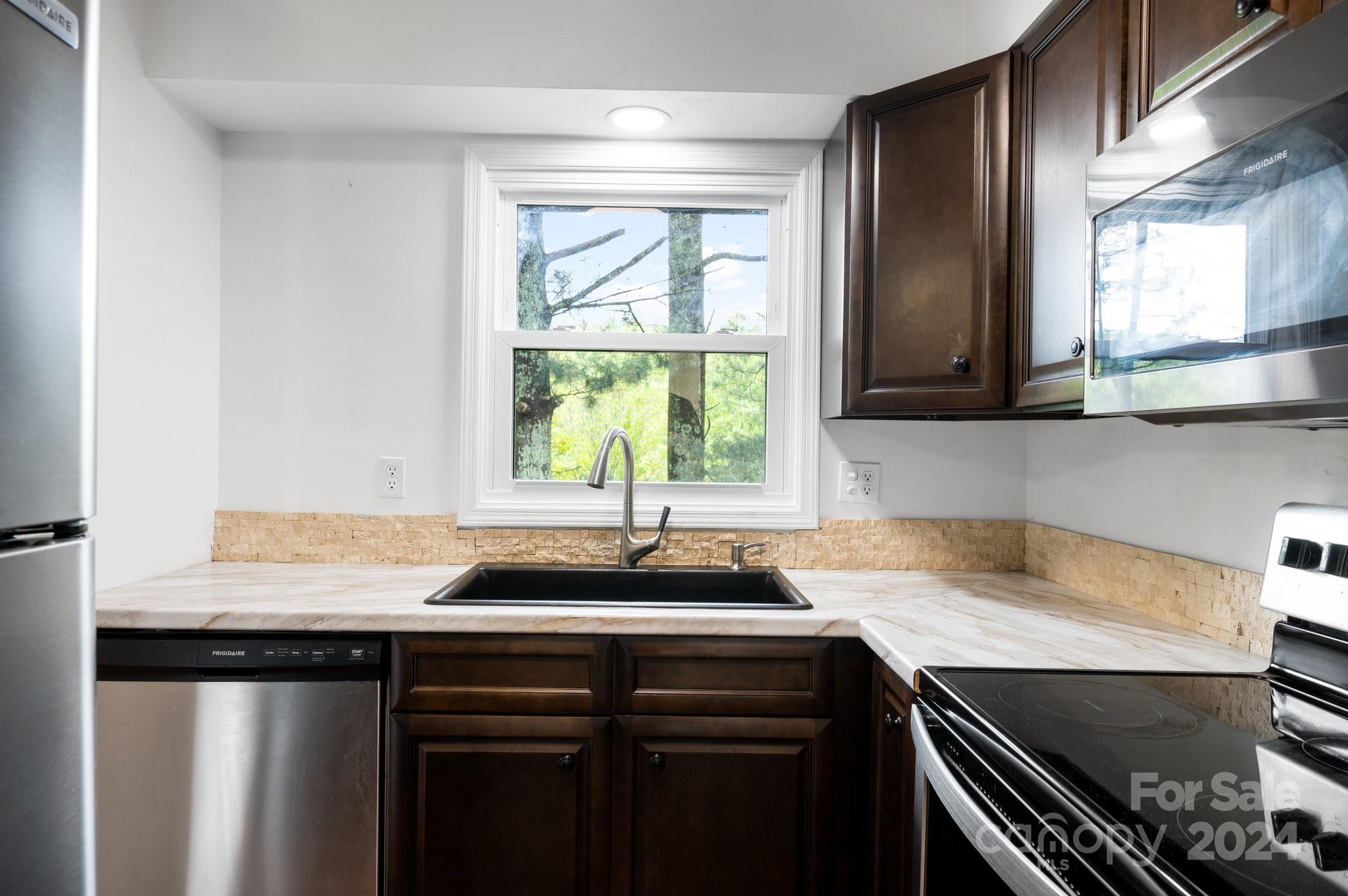 12 South Ridge Place Arden, NC 28704 - Photo 11 of 41 a kitchen with a sink and a window